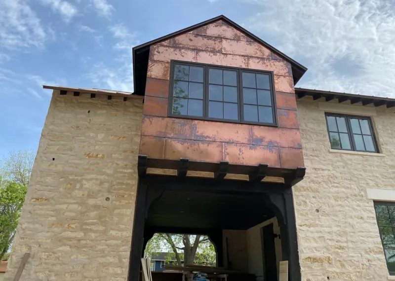 Copper metal panel facade on a stone building for Skylight Installation in West Hattiesburg